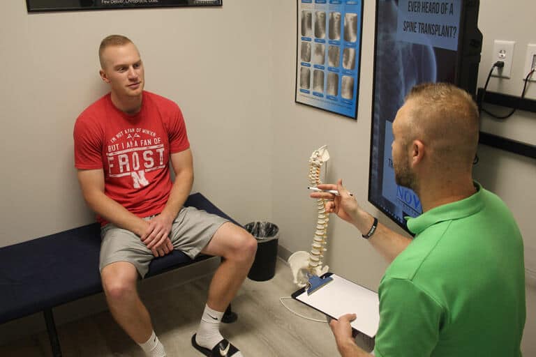 Dr. Shane Davidson DC in discussion with Patient at Novo Chiropractic Lincoln clinic